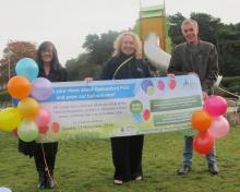 Cllrs Christine Mitchell, George Adamson and Lynn Evans holding up banner in Hednesford Park