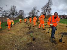 Volunteers from Amey planting trees