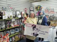Councillor Diane Todd in a retail unit with retailer holding banner