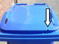 Blue bin with arrow showing where notch is removed on right hand side of front of lid