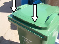 Green bin with arrows pointing to where notches are removed either side of the front of the lid