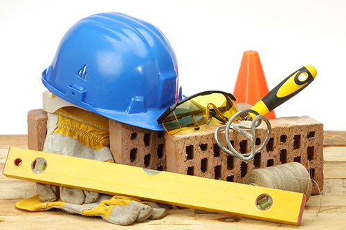 Building tools, helmet, goggles, bricks and cone