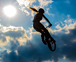 person on bmx in mid air